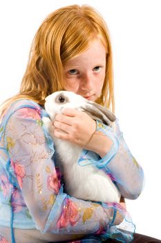 redhead girl is cuddling with a white rabbit isolated