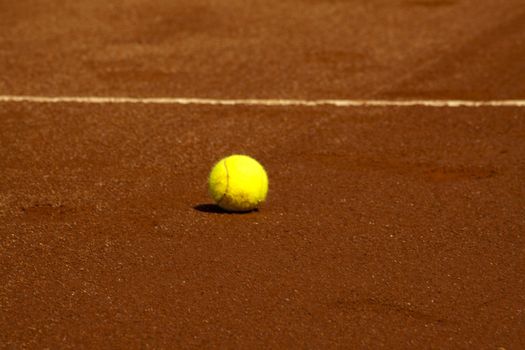 A tennis ball on a red field