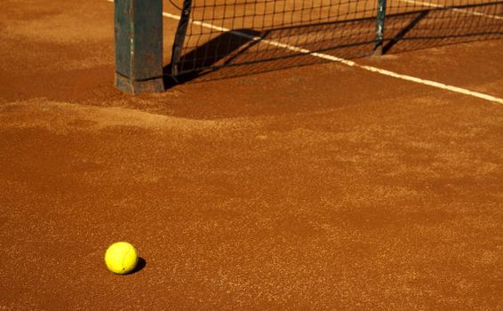 A tennis ball on a red field