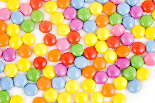 Lots of colorful smarties on white