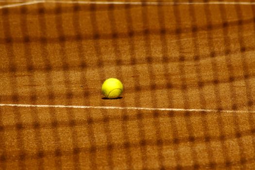 A tennis ball seen from beyond the net