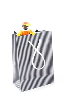 zwarte pieten in a shopping bag, characters from a traditional dutch holiday; isolated on white