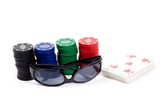 a deck of cards and casino chips isolated on white