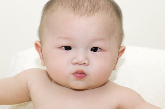 Horizontal portrait of a adorable 6-month-old Asian baby boy 