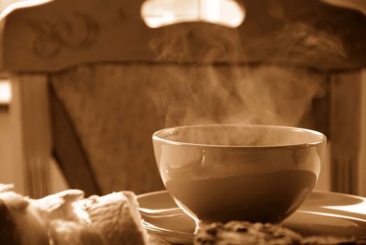dinner served on table, hot soup in bowl in sepia colors