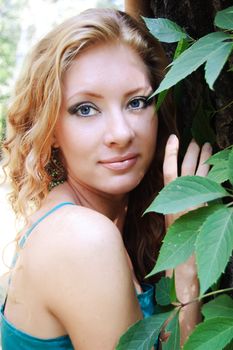 Beautiful red-head woman in forest