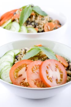 Delicious Asian Vegetable Fried Rice, containing tomato, cucumber, chinese long bean, and basil.
