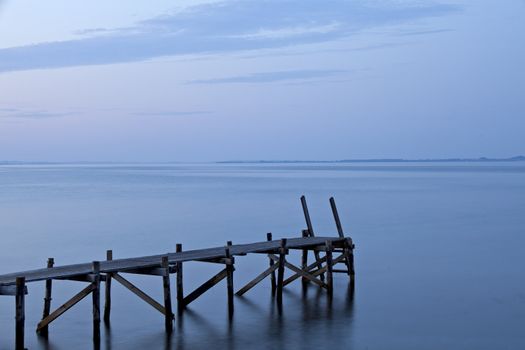 silhouette of a footbridge at the sea