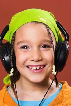 little pretty child listening music in headphones