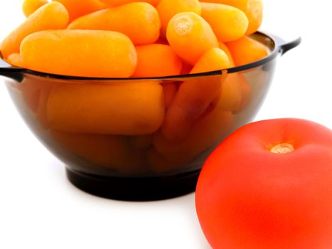  carrot in bowl and tomato near it against the white background