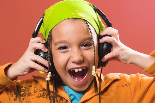 little pretty child listening music in headphones