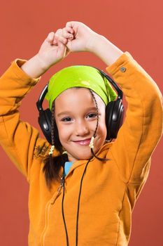 little pretty child listening music in headphones