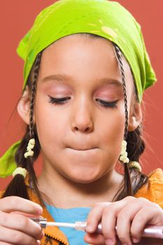 young pretty child applying make-up