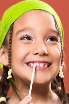 young pretty child applying make-up