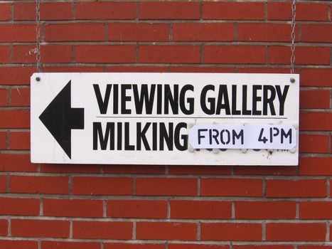 Sign Pointing to Milking Gallery at Dairy Farm