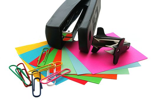 Colour sheets of paper for record with paper clips and a stapler.