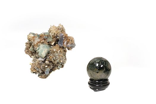 The granite polished sphere on a support and crystals for spiritualistic sessions.