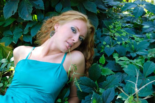 Lady in green dress lying on grass