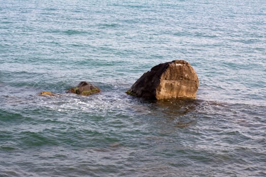 Crimea coast in summertime: stones in water
