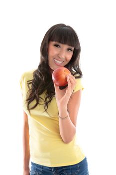 Attractive smiling woman eating a healthy choice food snack.  She is holding a ripe red apple in her left hand.