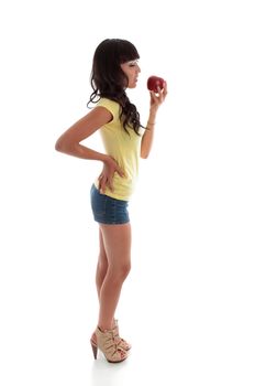 A healthy fit young woman eating a juicy red apple.  White background.