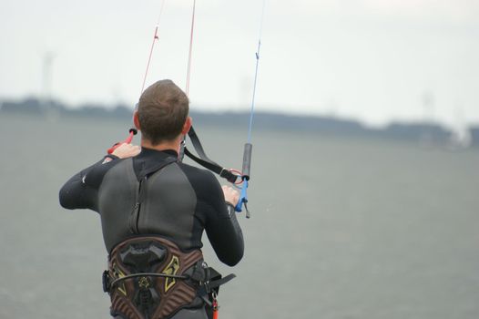 A man is kite surfing at the beach