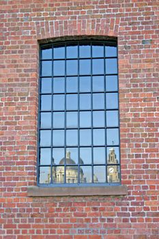 Liver Building  and 3 Graces Reflected in Warehouse Window in Liverpool UK