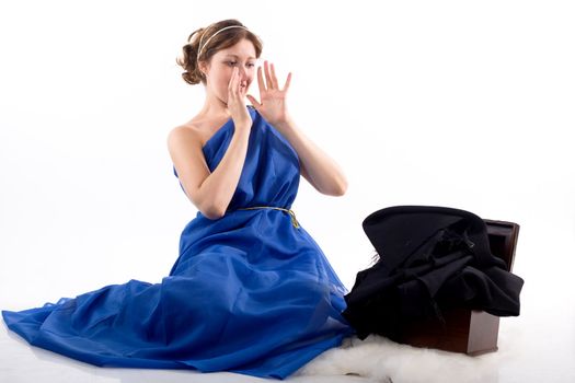 Lady in blue antique dress and open box on white background
