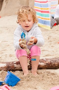 Having fun with sand on the beach.