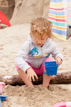 Having fun with sand on the beach.