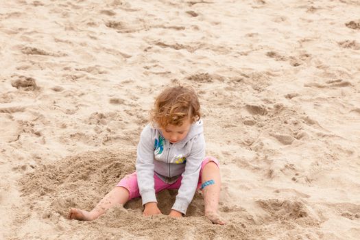 Having fun with sand on the beach.