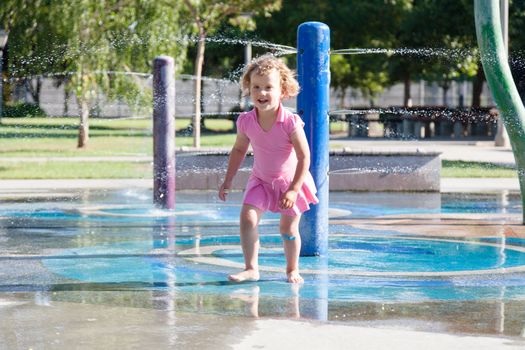 Having fun with water at the playground in park