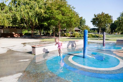 Having fun with water at the playground in park