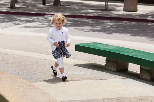 Having fun running around the fountain in the park.