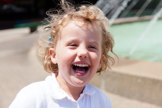 Having fun running around the fountain in the park.