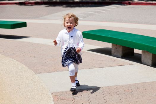 Having fun running around the fountain in the park.