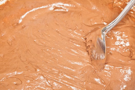 Preparing chocolate cupcakes for baking in oven.