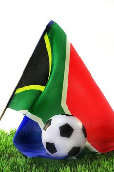 South African flag with a leather ball on a lawn