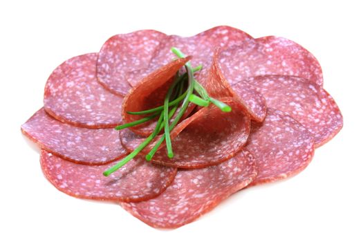 Salami slices garnished with chives
