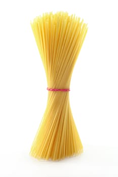 uncooked spaghetti, standing against a white background