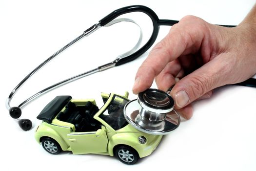 Stethoscope with car in front of white background
