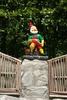 statuette of the small gnome playing on harmony