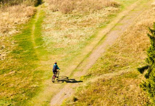 Mountain biker on off-road trail branching off.