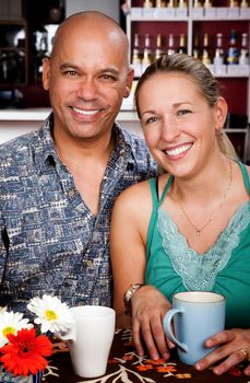 Attractive man and woman posing in a coffee house 