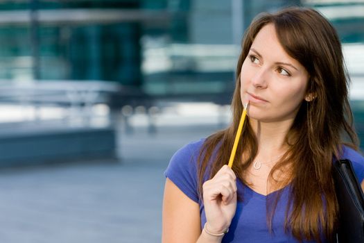 Pretty caucasian white girl pondering or thinking outside college school