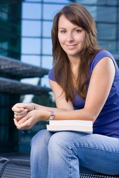 Pretty attractive caucasian girl sitting relaxing outside college school