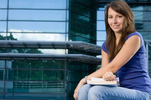 Pretty attractive caucasian girl sitting relaxing outside college school