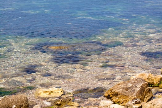 Crimea coast in summertime: stones in water
