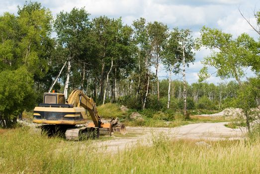 An unused excavator sitting at a job site, ready for moving dirt or gravel