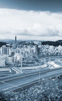 It is a cityscape photo of apartments and highway.